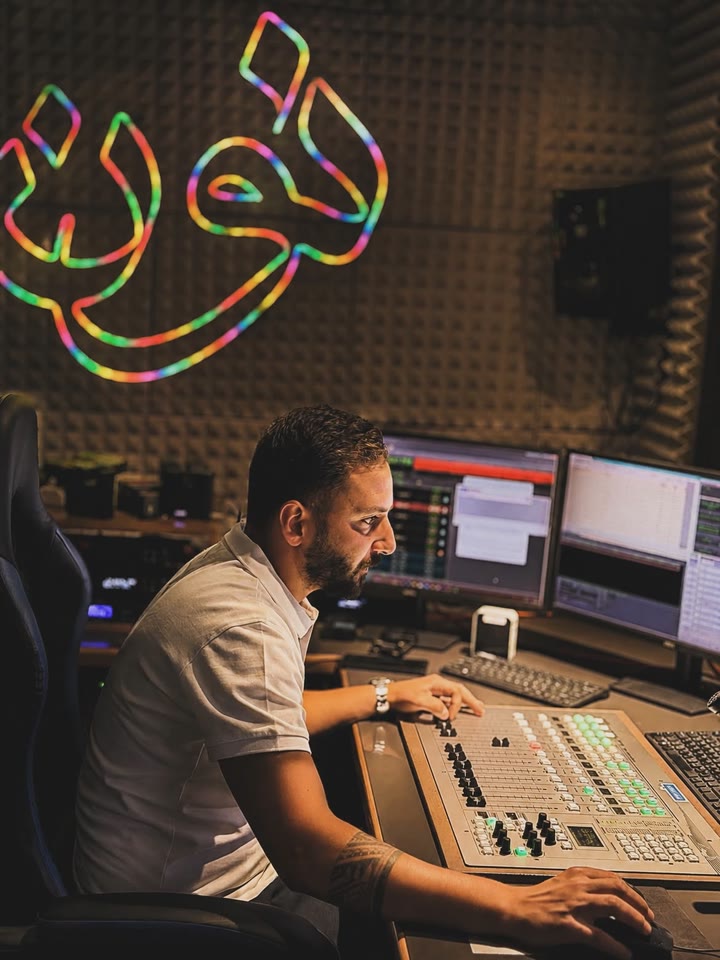 Hamzeh behind a broadcast console
